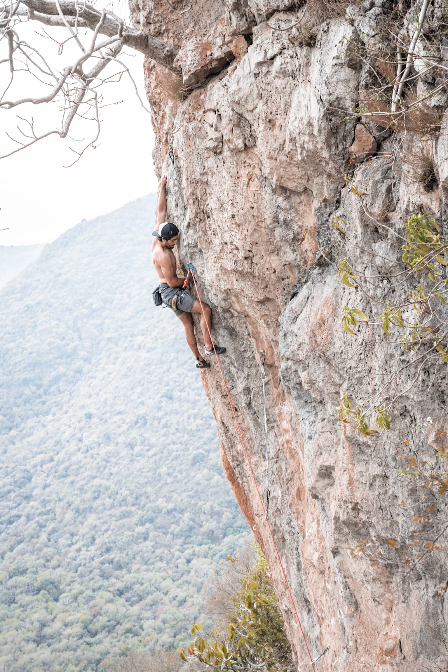 Climbing through steep rock with open mountain air below